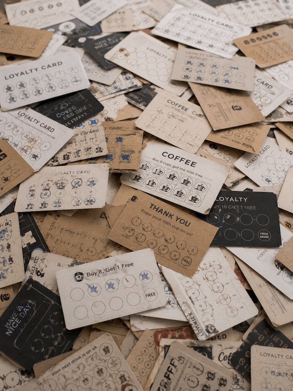Messy pile of paper loyalty stamp cards